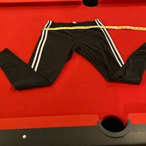 Black leggings with white stripes on the side. Medium (7-9)
